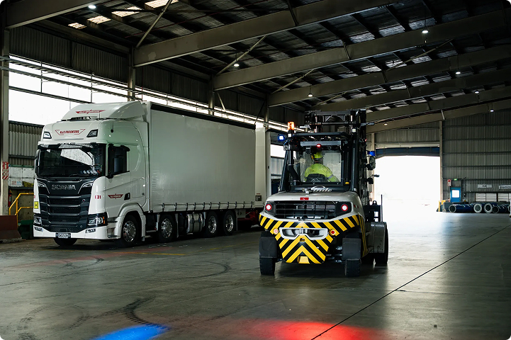 Forklift detecting a pedestrian behind warehouse racking