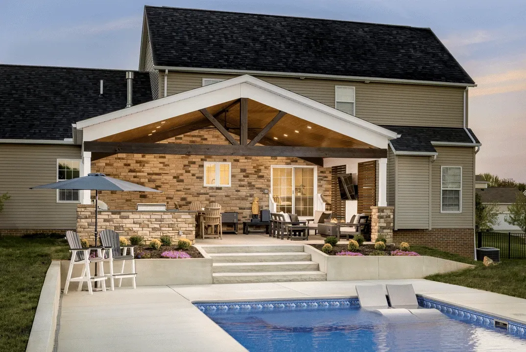 outdoor room behind home timber frame roof and stone walls