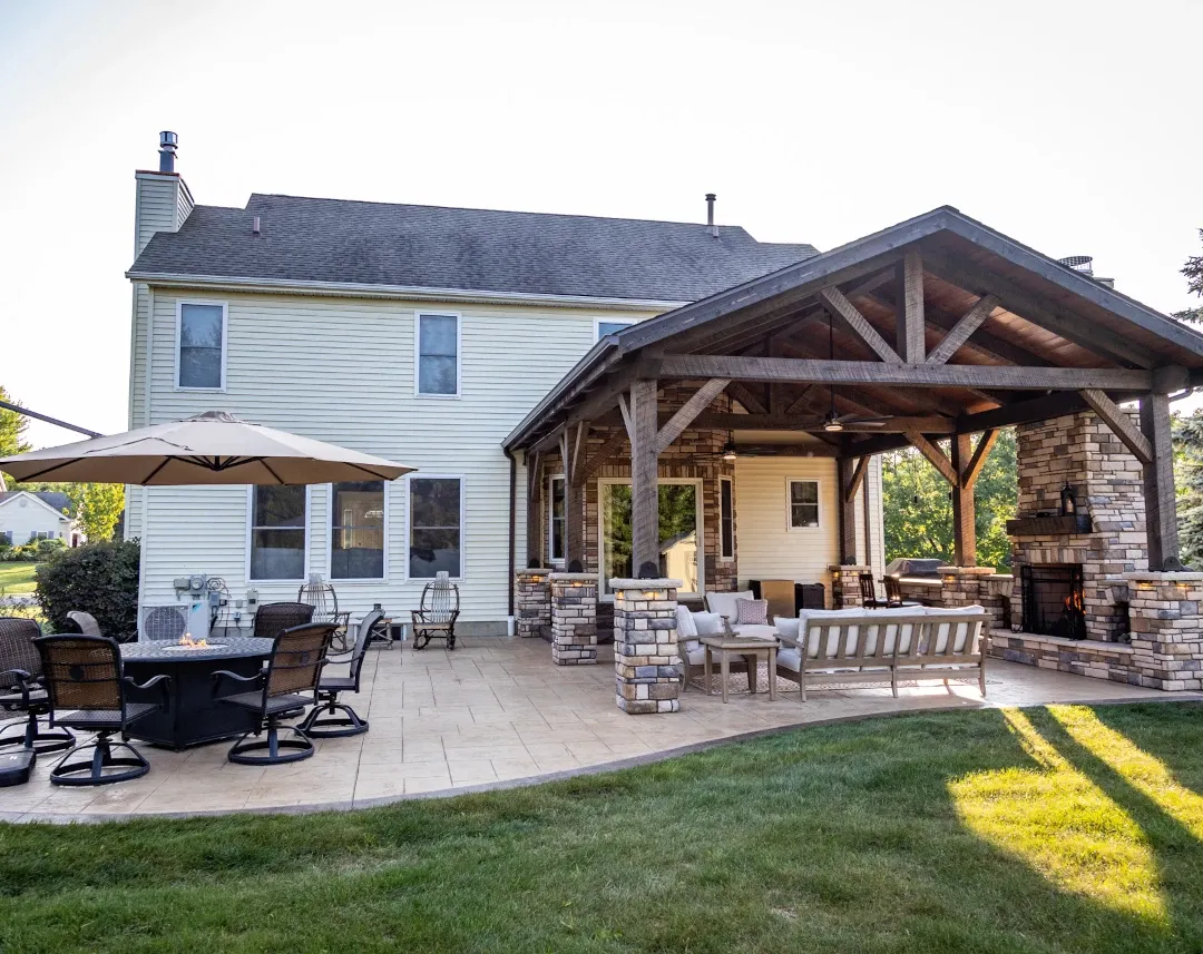 outdoor patio with timber frame awning room and firepit area