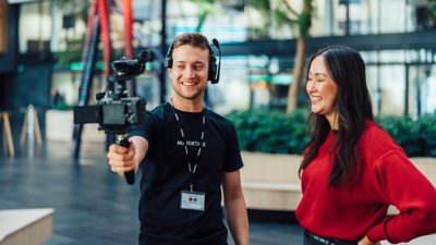 Majortale videographer filming a woman with a handheld camera rig