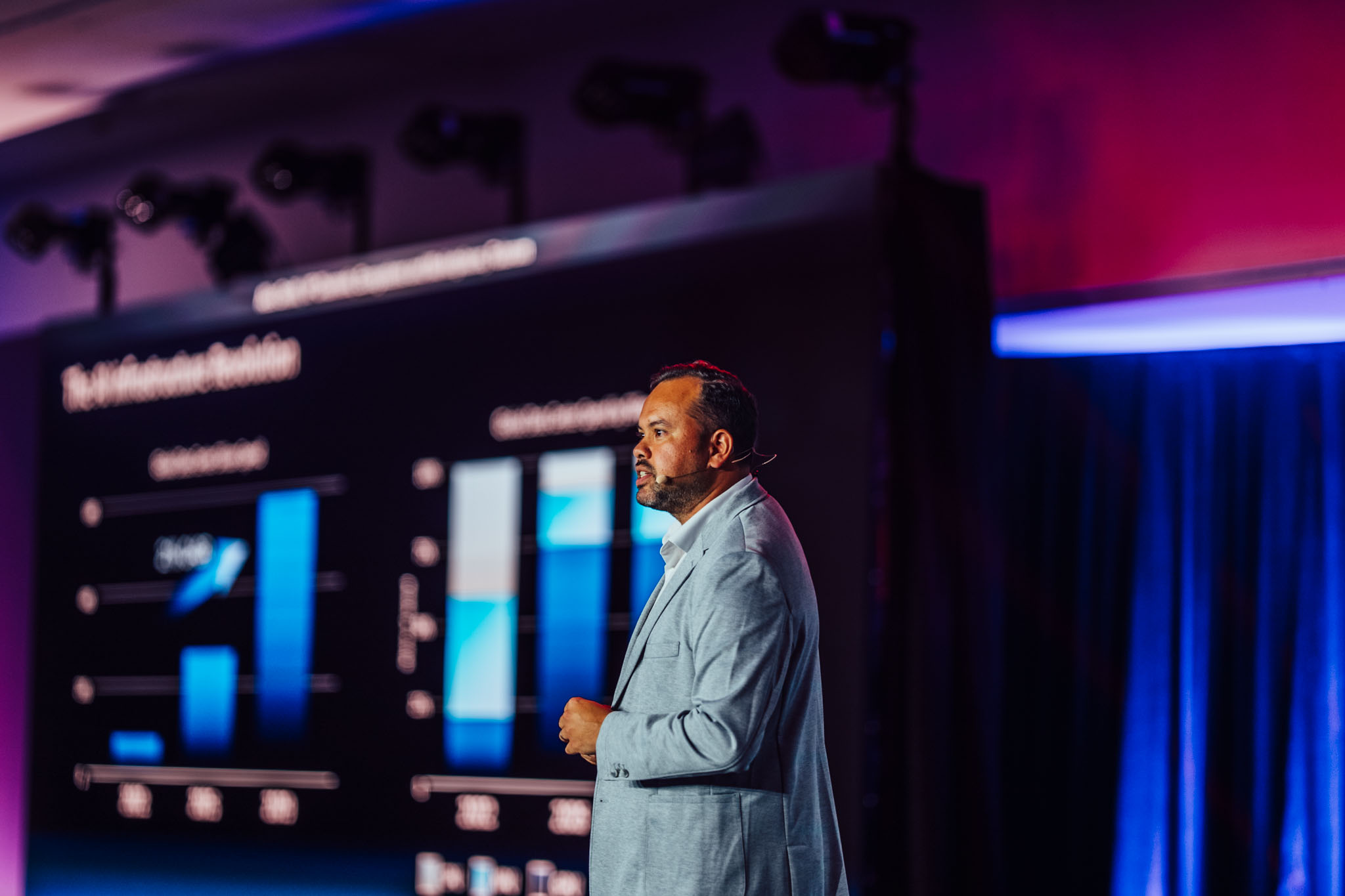 Presenter on stage in front of data charts at Lenovo 360 Accelerate 25 Monaco