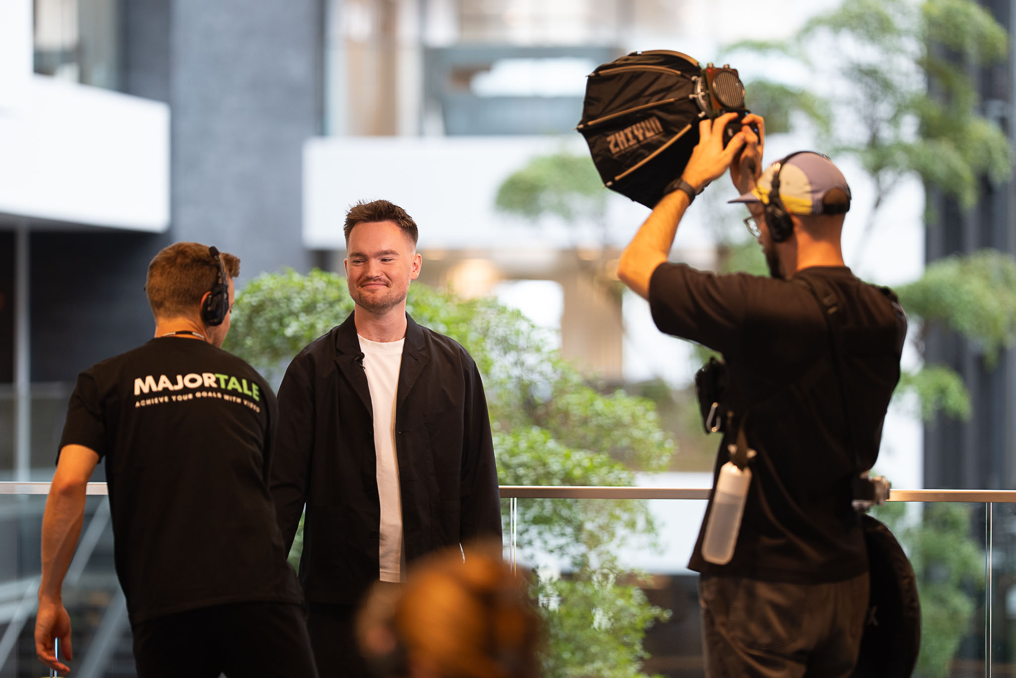 Majortale crew preparing lights around a man before an interview