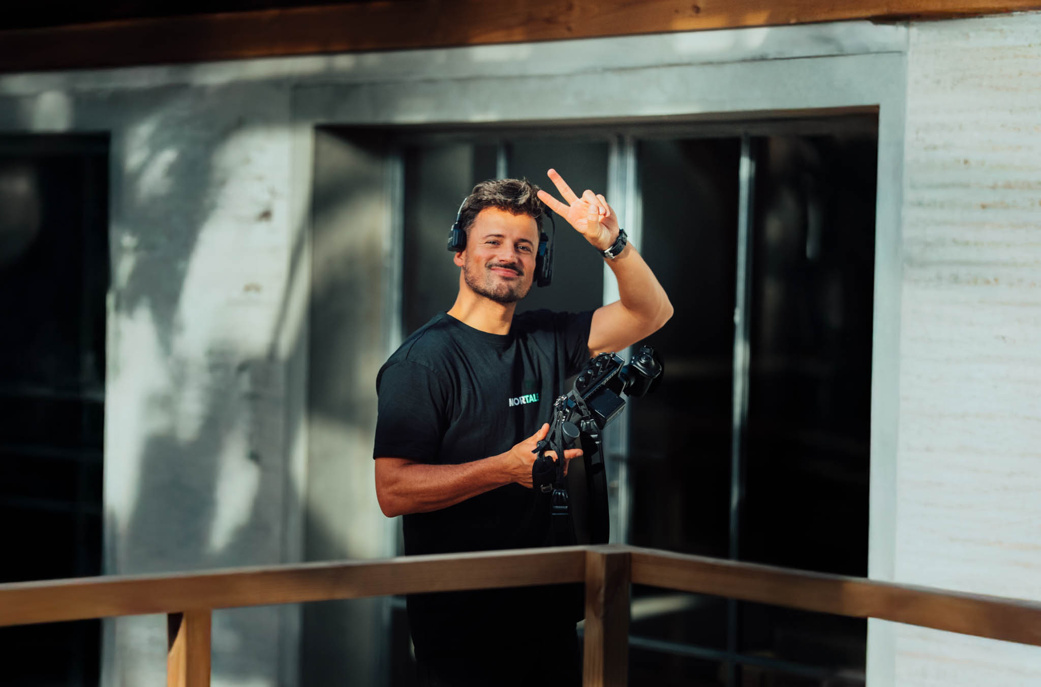 Majortale camera operator waving on set