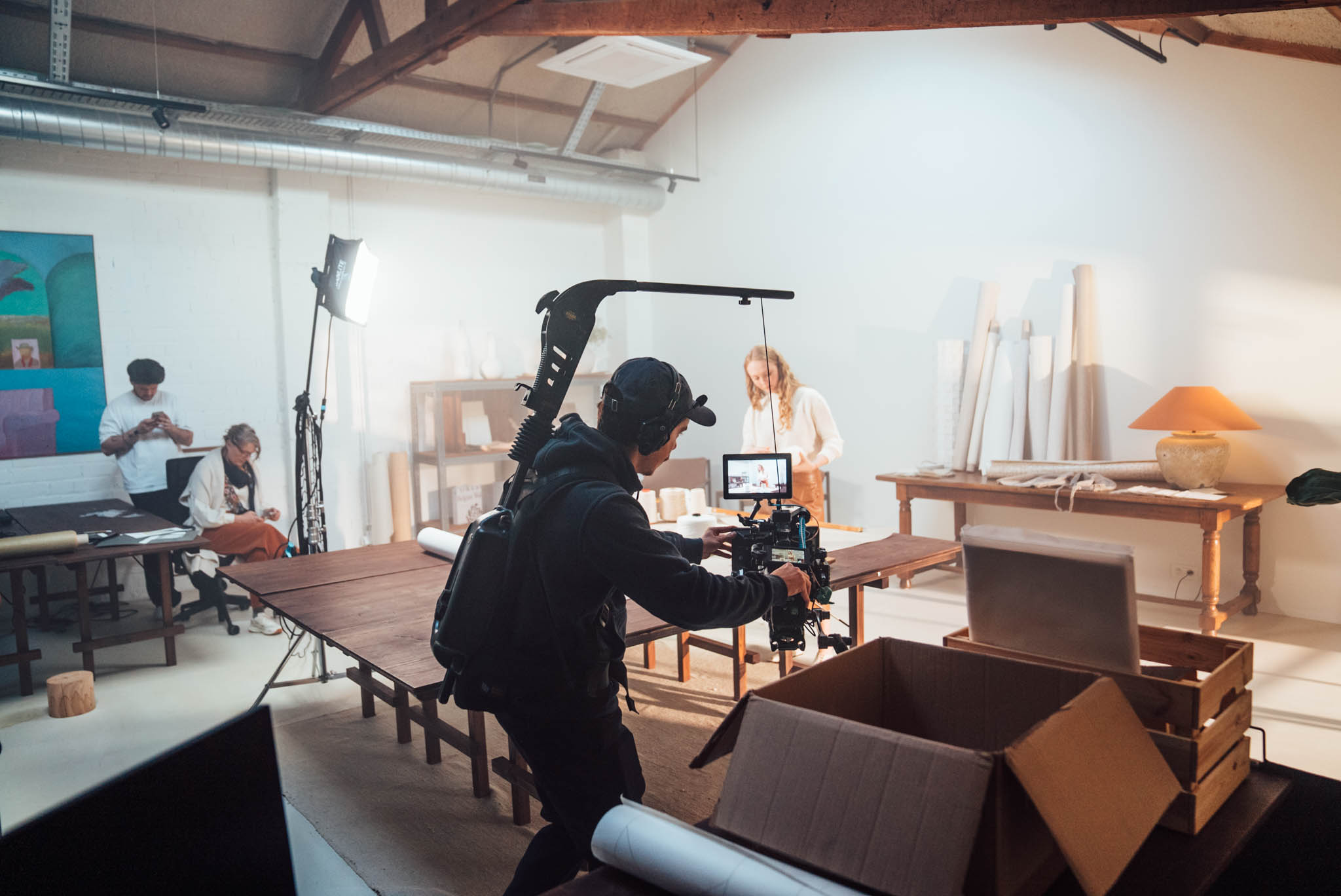 Camera operator filming a styled interior set for Omexco