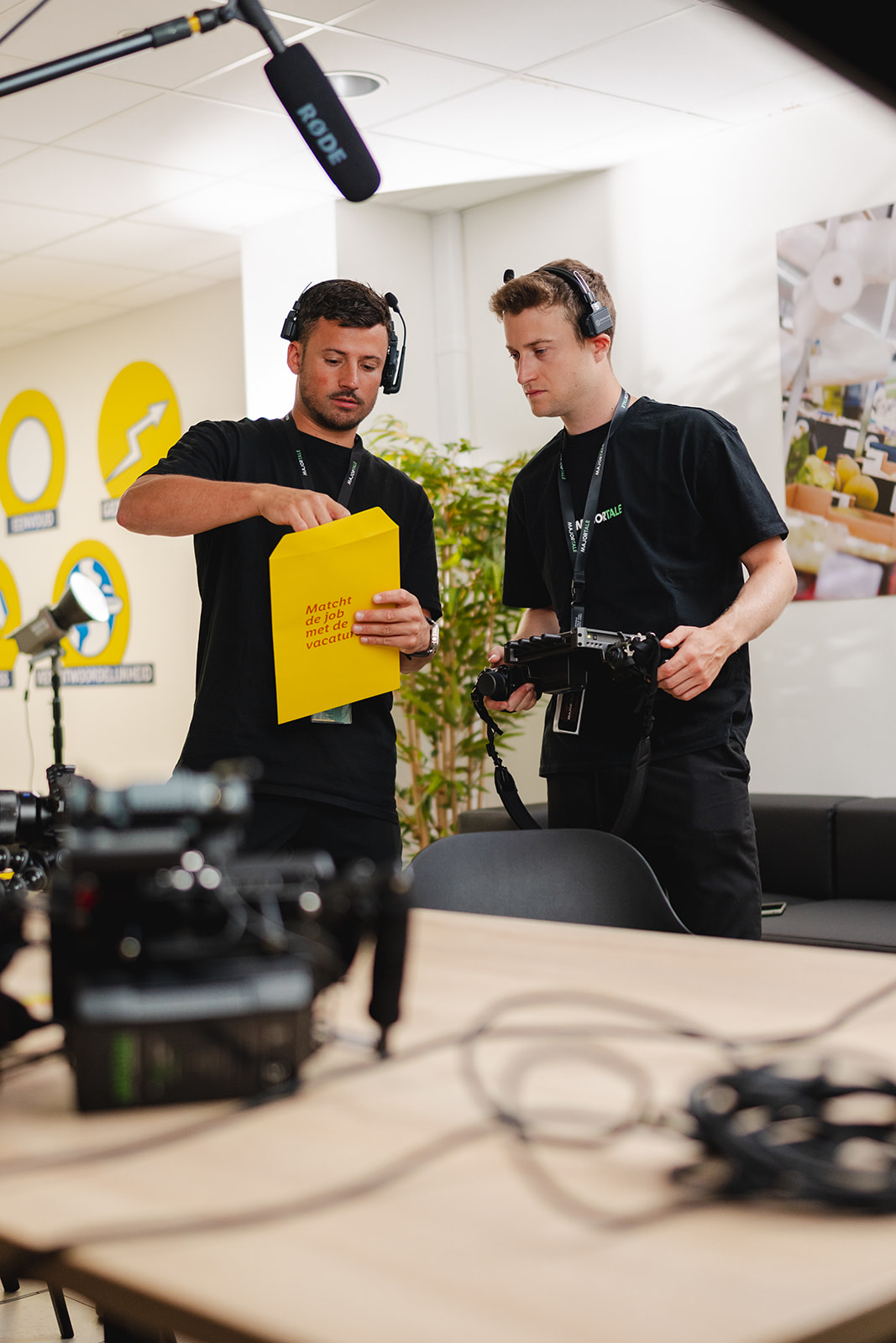Two crew members reviewing a script on the Lidl employer branding set
