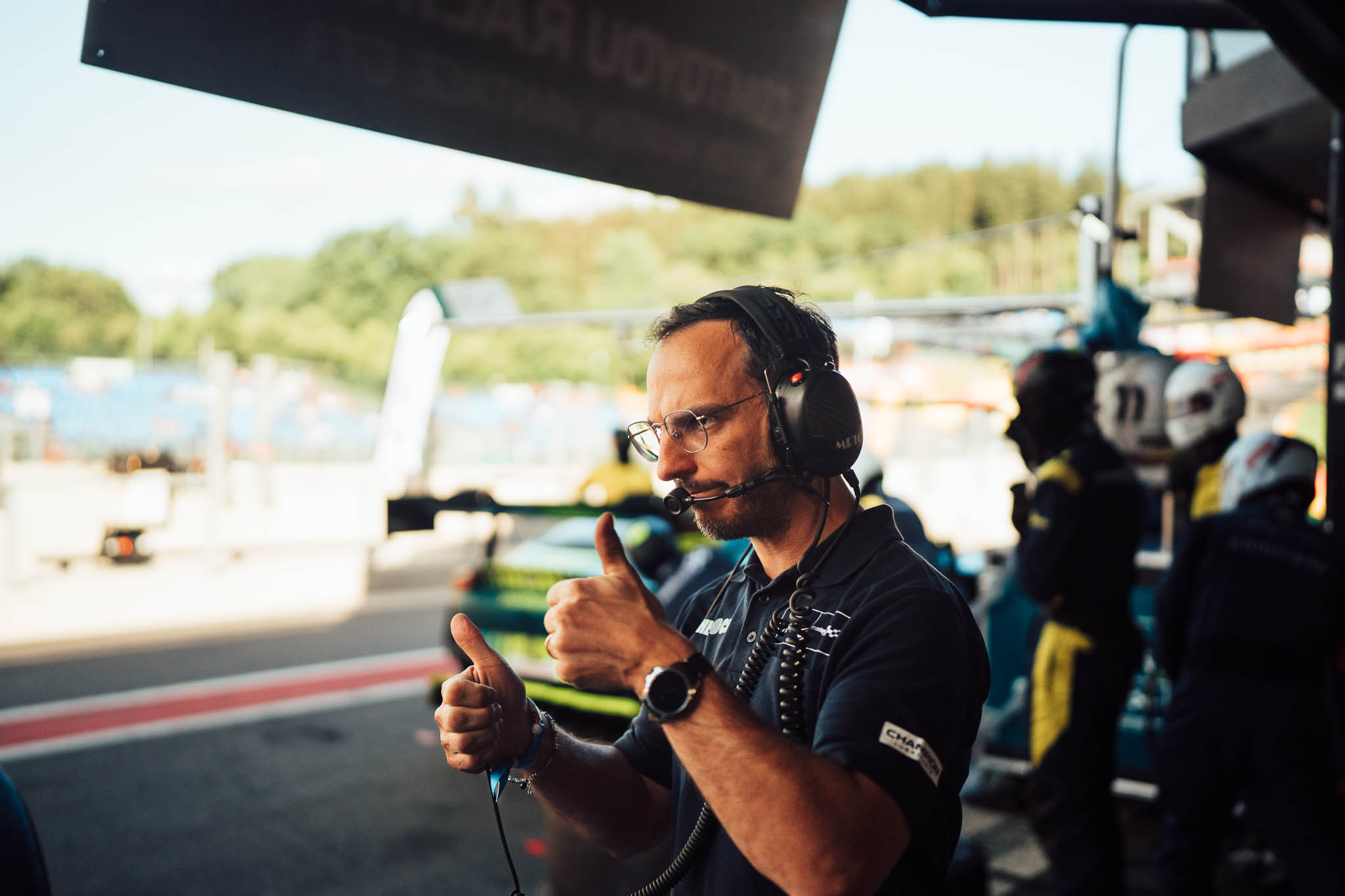 Race engineer with headset giving a thumbs up in the pit lane at Spa-Francorchamps