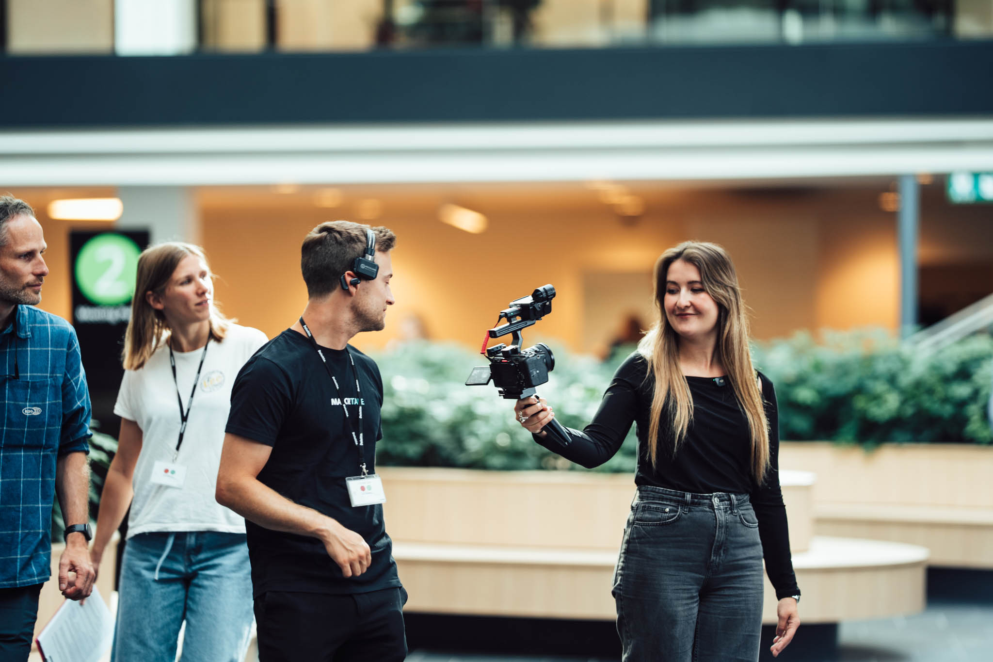 Majortale crew guiding a Deloitte graduate on set