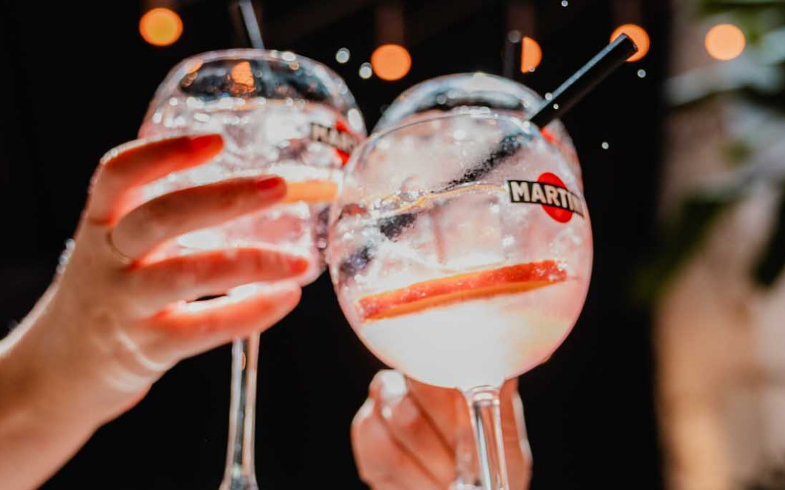 Martini cocktails raised in a toast, product shot by Majortale