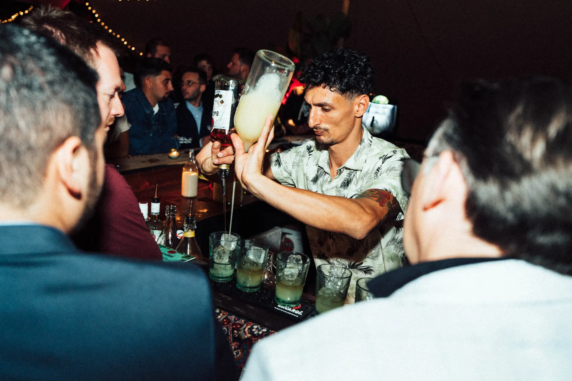 Bartender pouring cocktails for guests at a Bacardi event