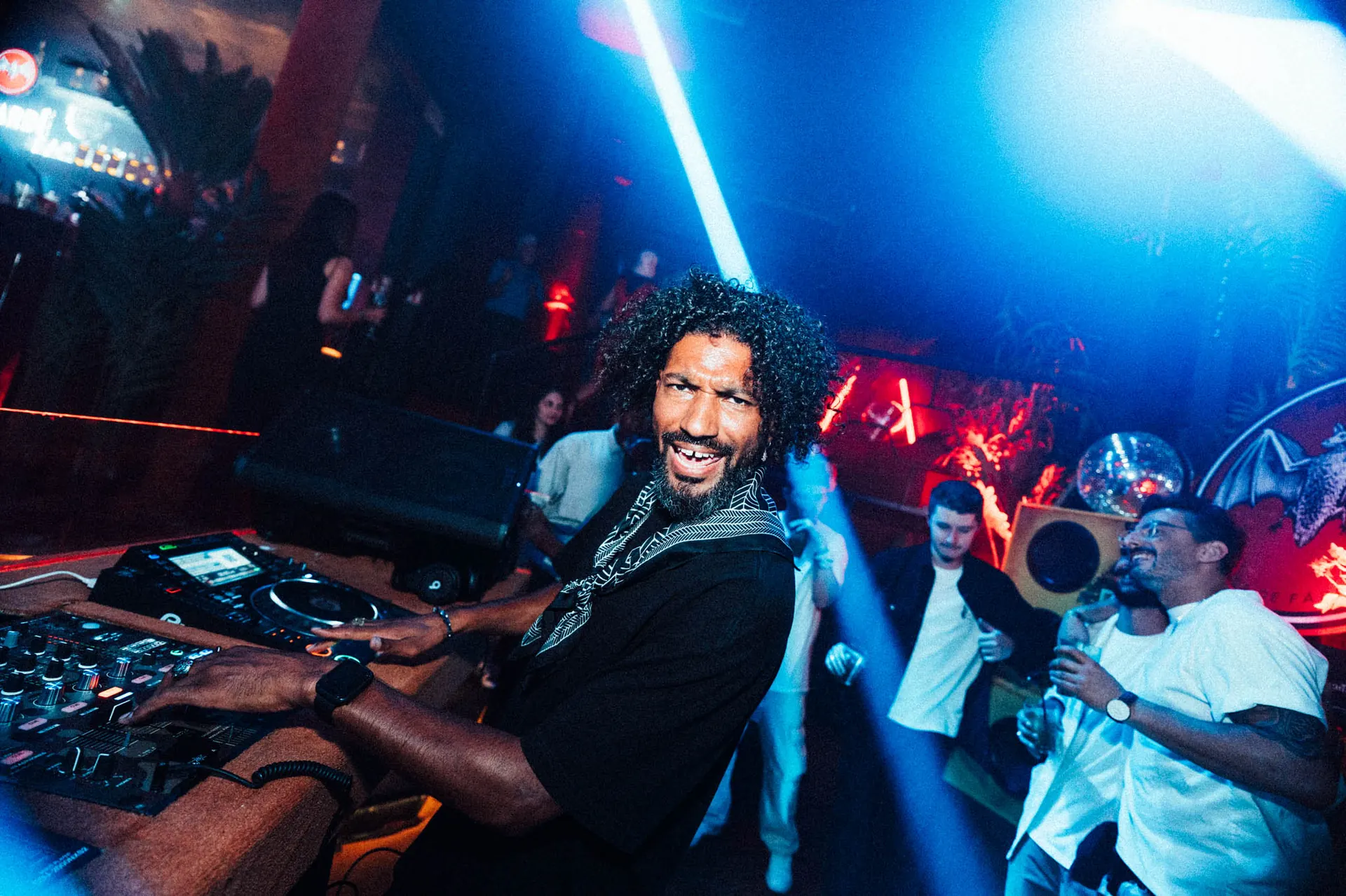 DJ smiling behind the decks at a Bacardi party, captured by Majortale