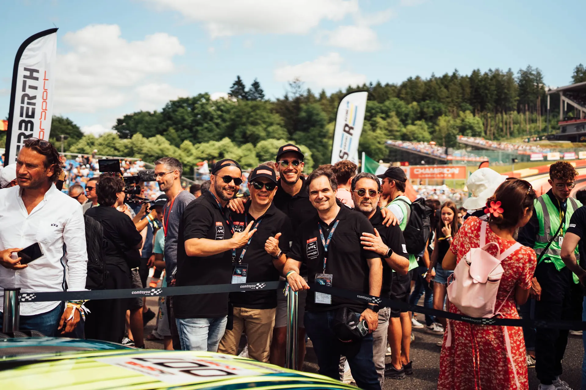 Crowd of fans and team members at the paddock during a Champion race weekend