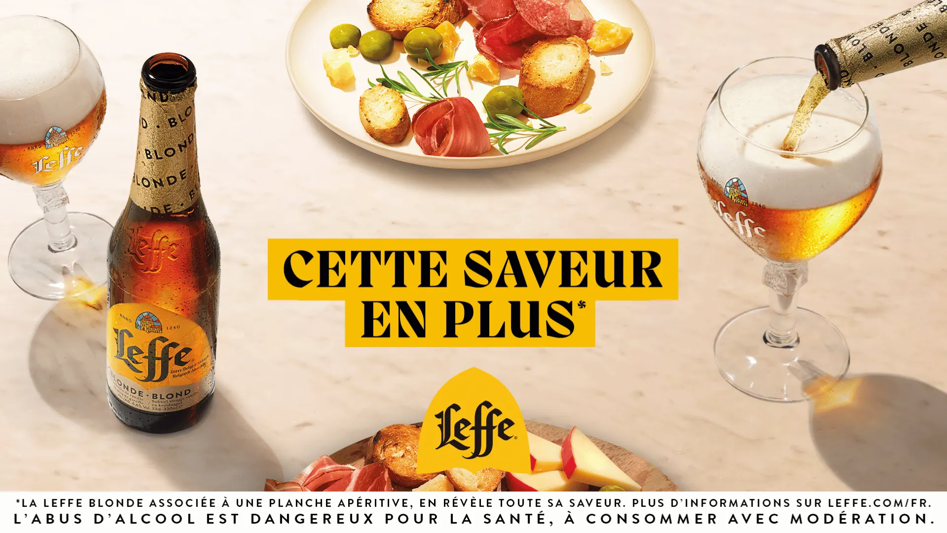 Leffe Blonde bottle and glass with an aperitif board, French print ad