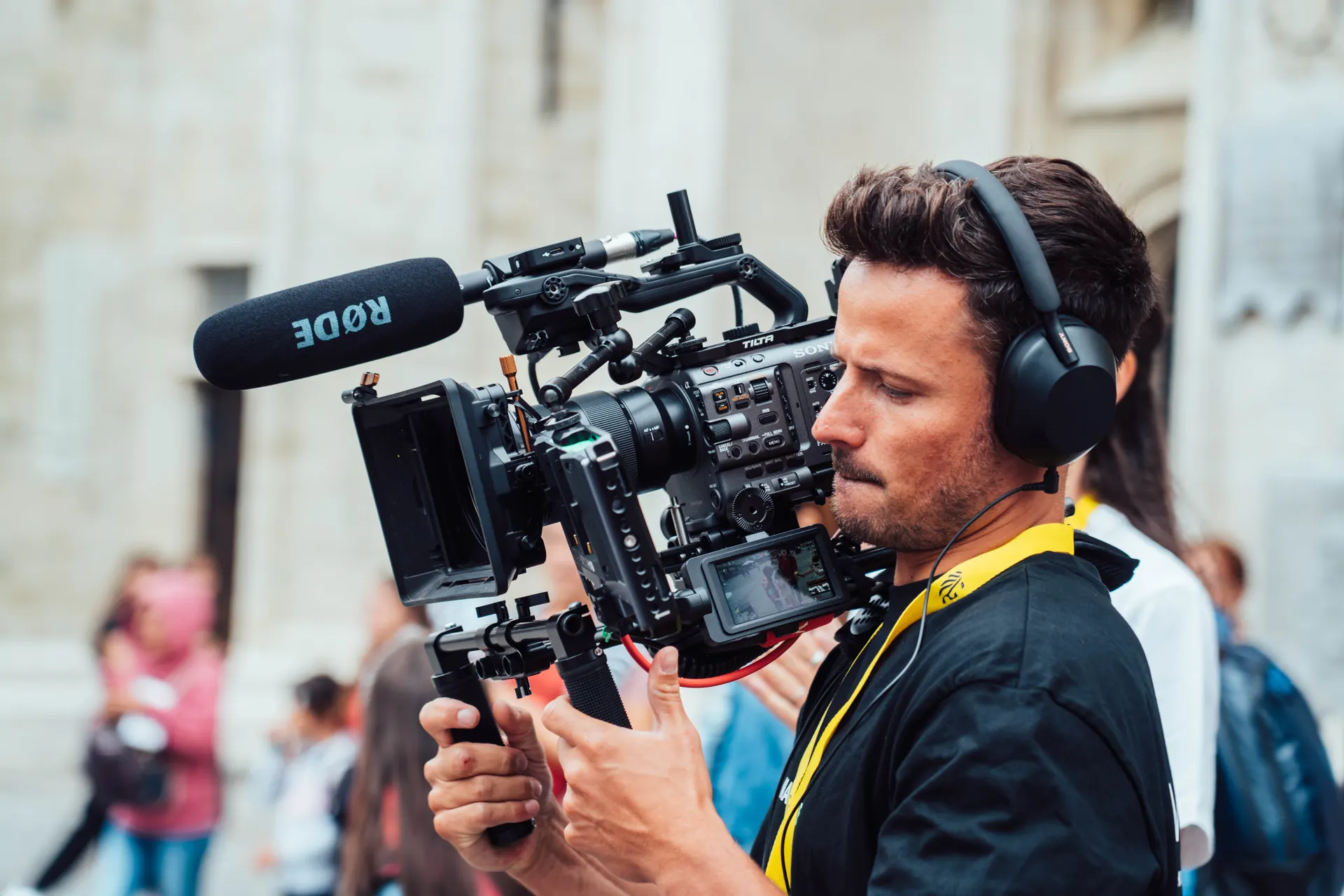 Camera operator filming a street interview in a Flemish city