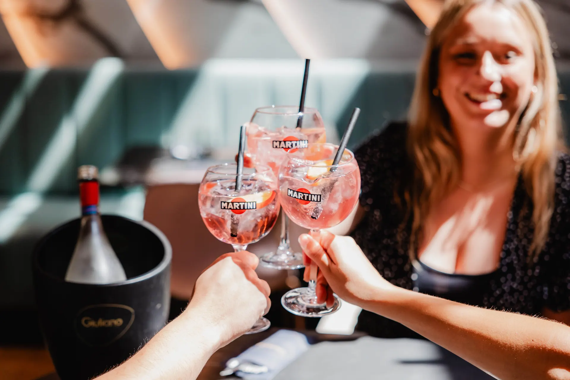 Friends toasting with Martini spritz cocktails