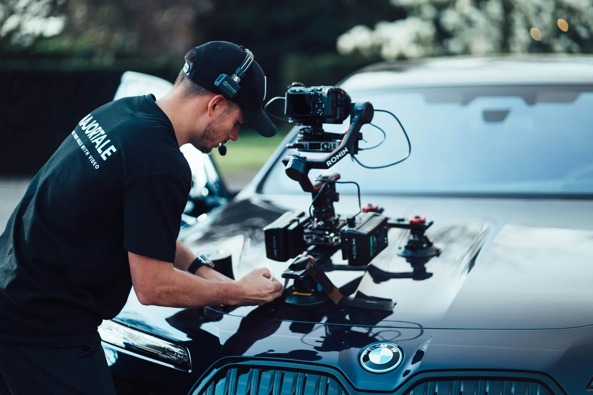 Majortale camera operator setting up a rig on the bonnet of a BMW