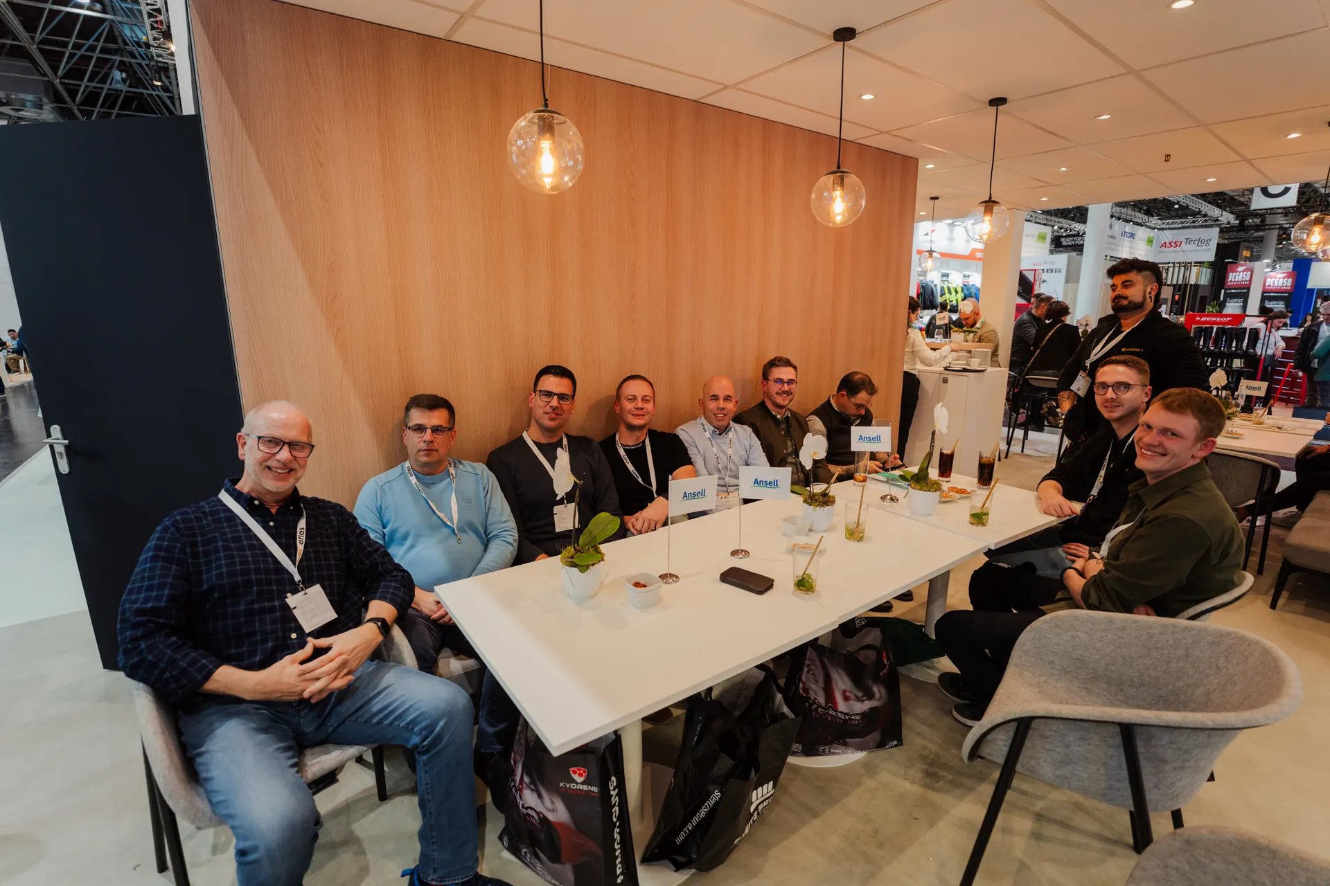 Group of professionals seated around a table at a trade fair stand
