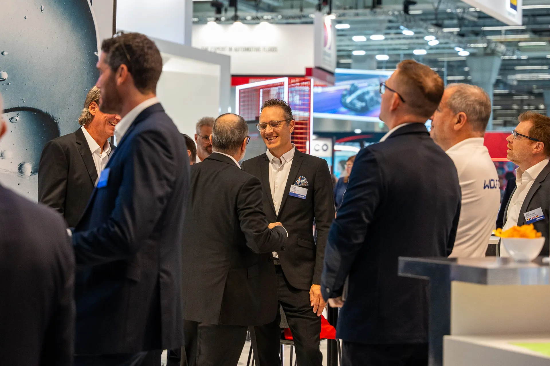 Business professionals networking at a trade fair stand