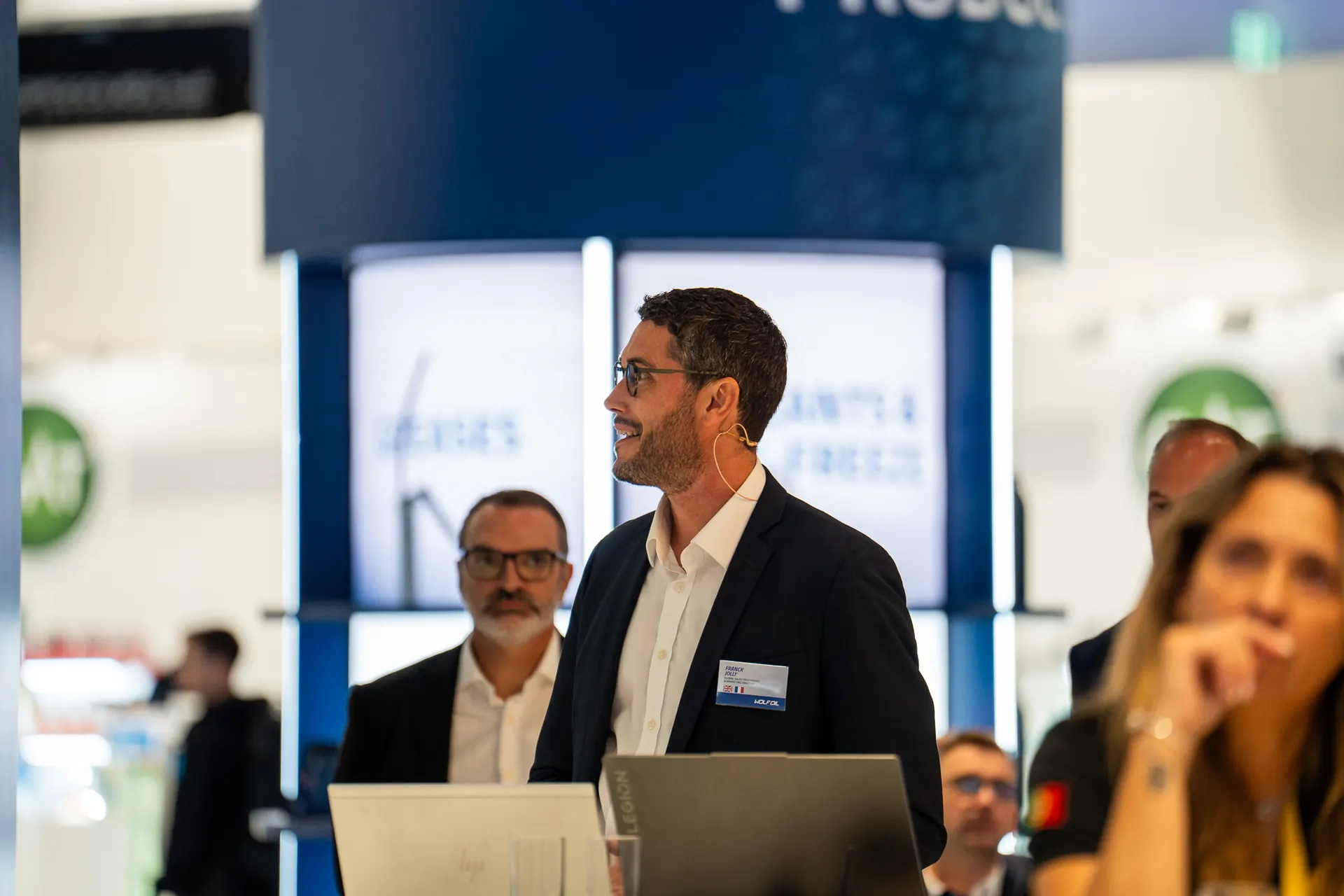 Speaker presenting at an industry event booth