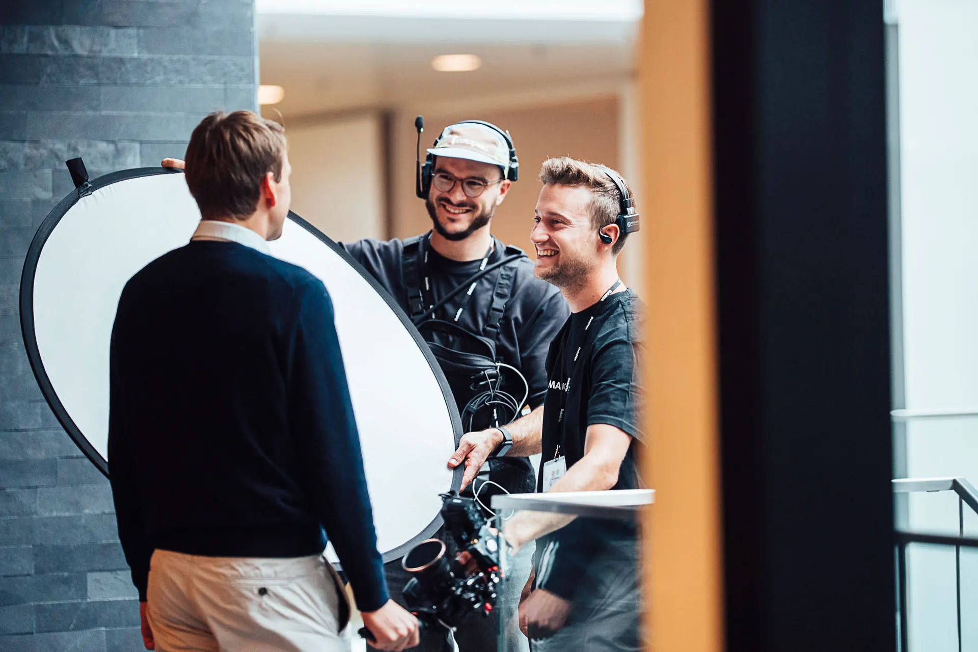 Majortale crew using a reflector to light an interview subject