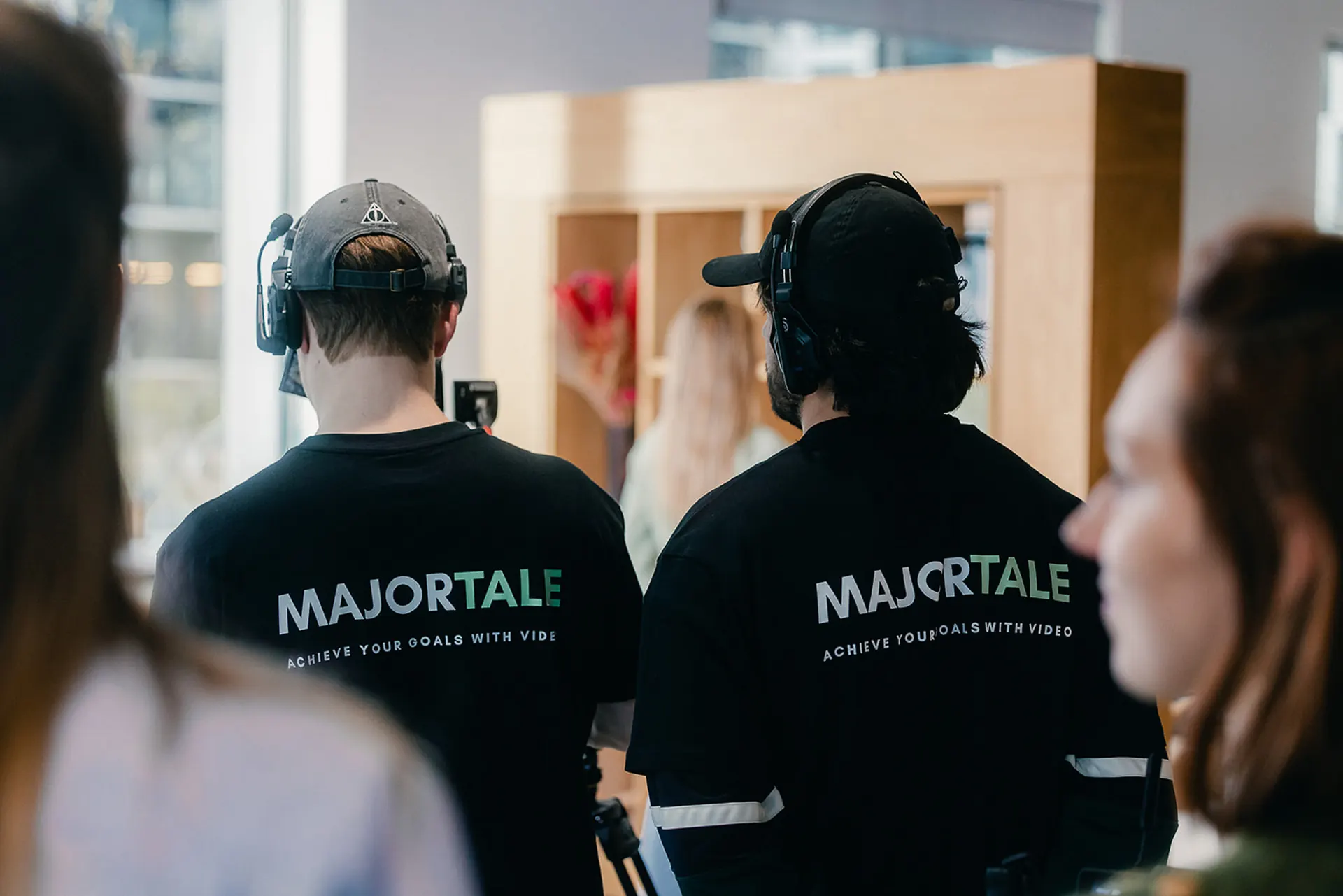 Two Majortale crew members in branded shirts on a shoot