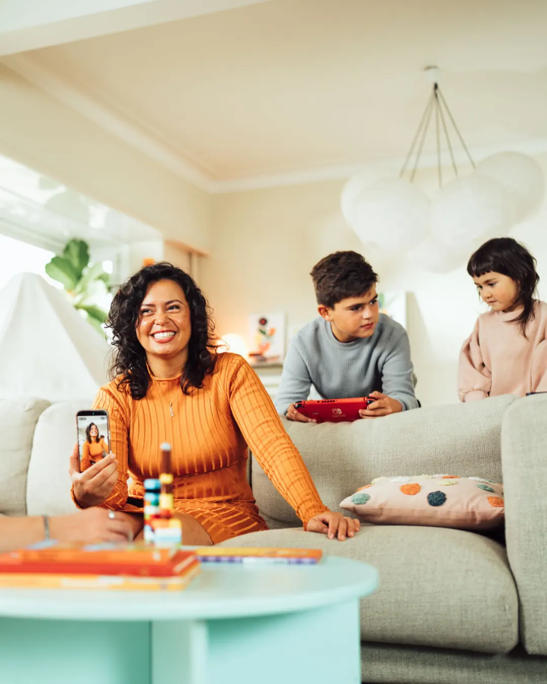 Family laughing on the sofa during the Eneco shoot