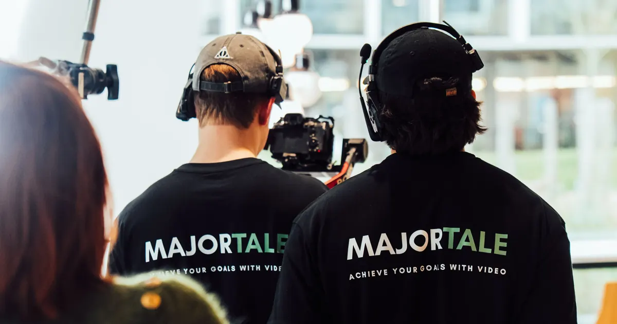Two Majortale crew members from behind with cameras and headsets