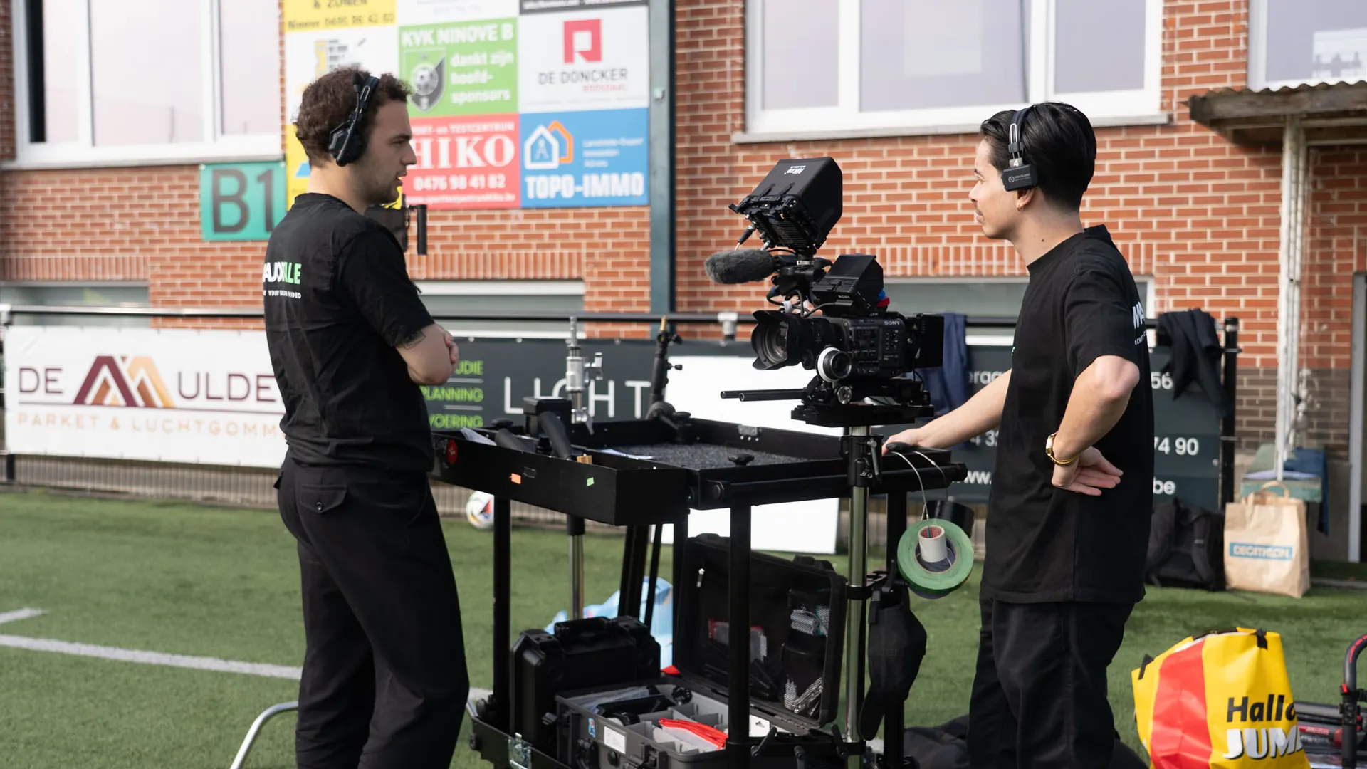 Majortale crew with a camera setup beside a football pitch