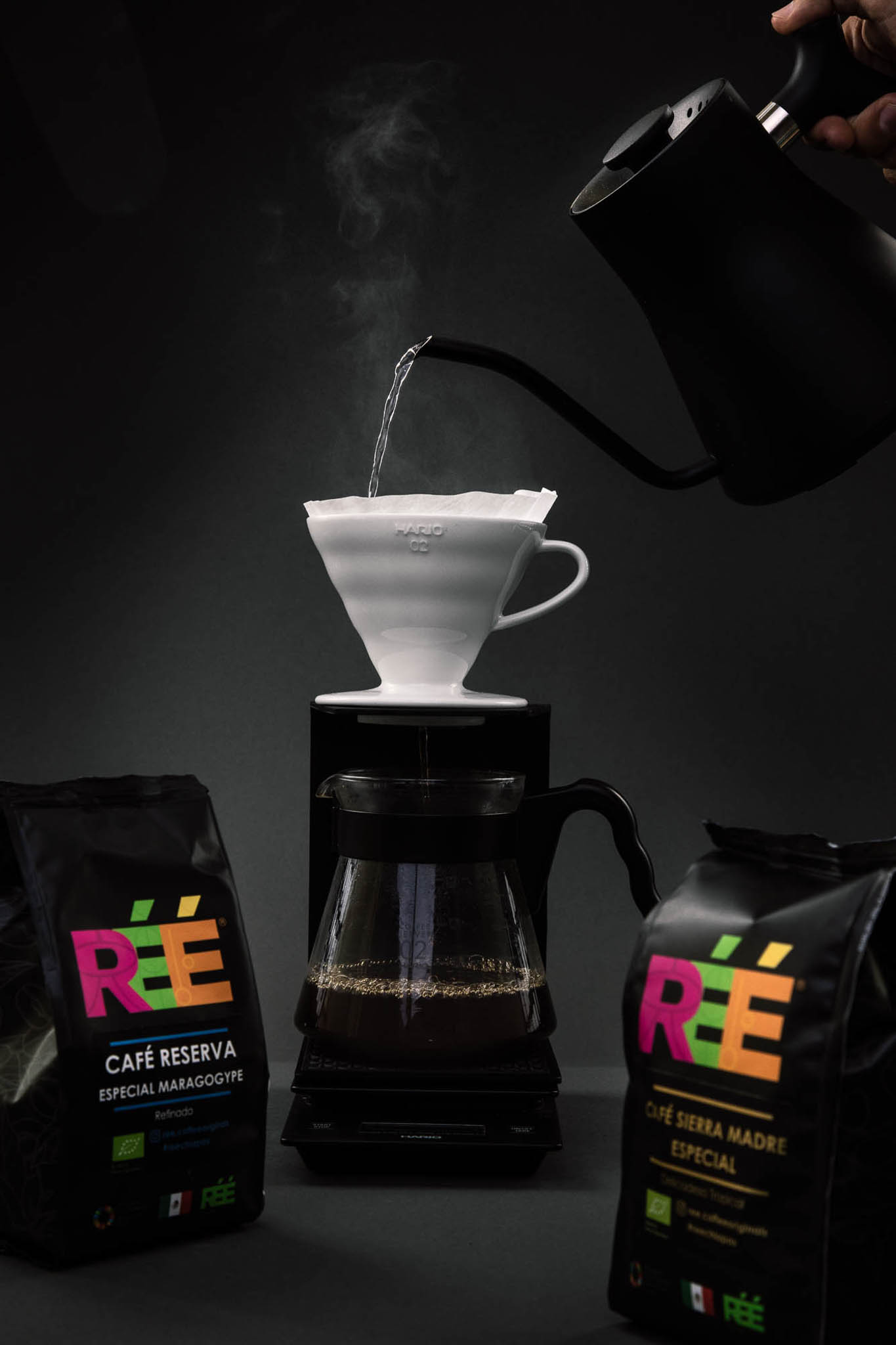 Pour-over coffee brewing between two bags of Réé Coffee
