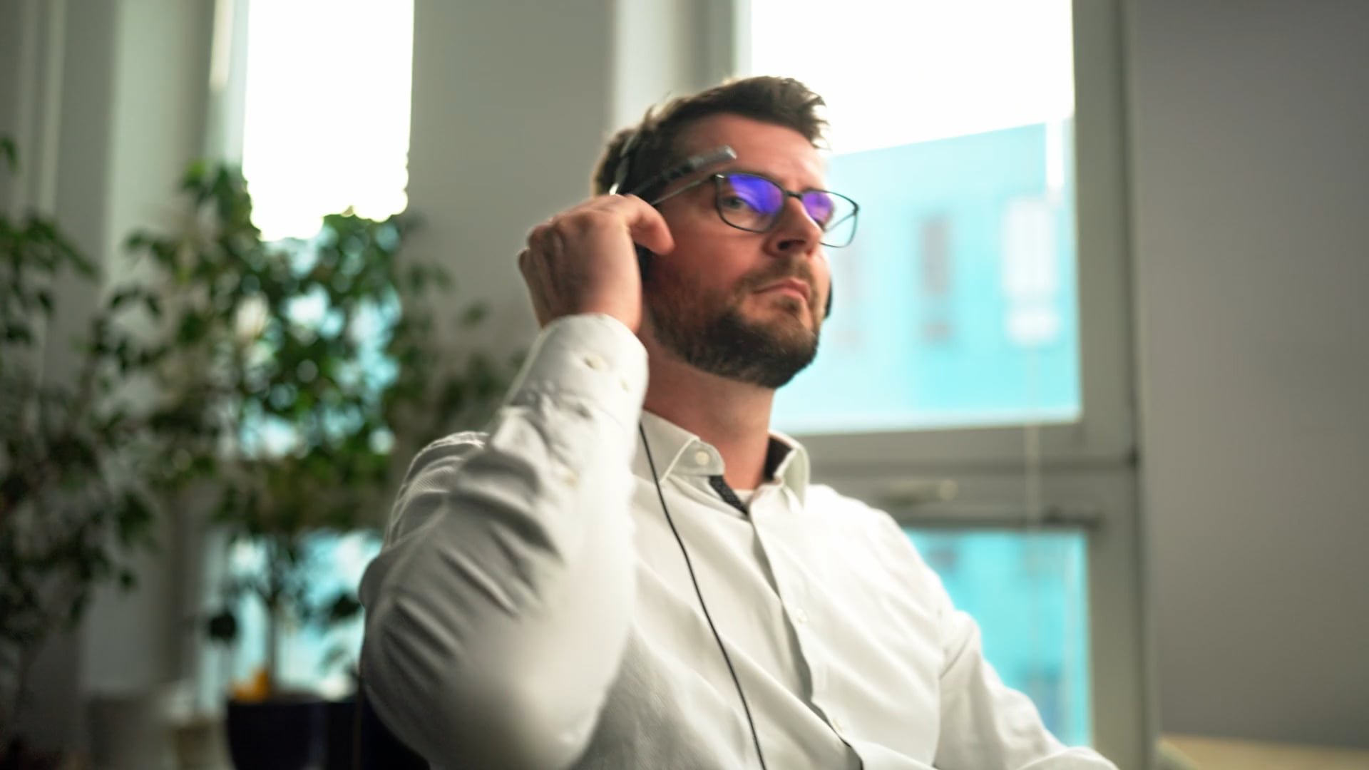 ATOZ manager wearing a headset in a bright office in Berlin