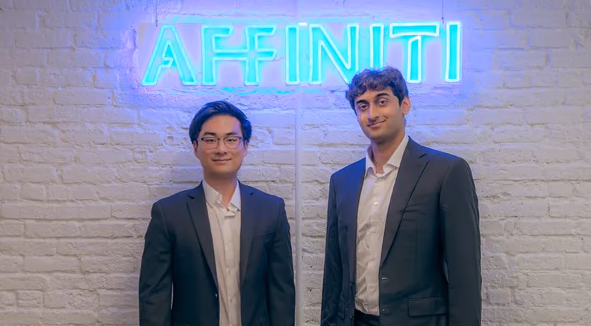 Aaron and Sahil under the Affiniti neon sign