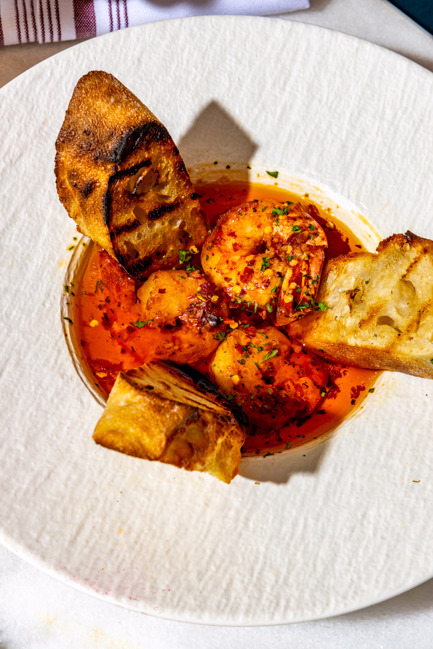Shrimp in chili oil with grilled bread at Mistora