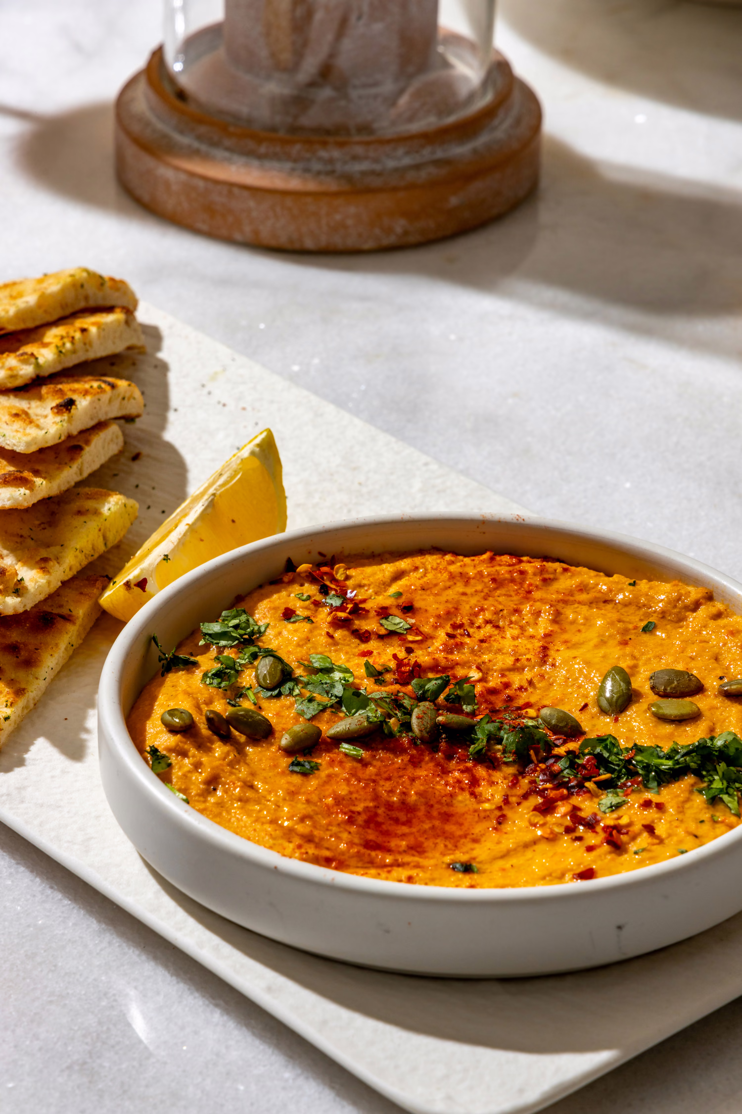 A red pepper dip with herbs and seeds, served with grilled flatbread and lemon at Mistora