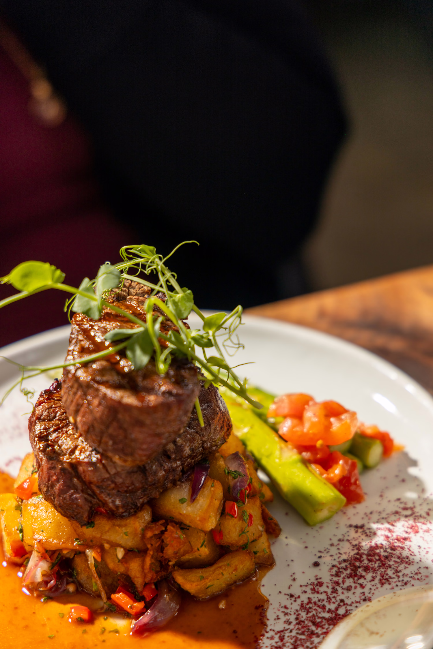A filet steak over roasted potatoes with asparagus at Divan