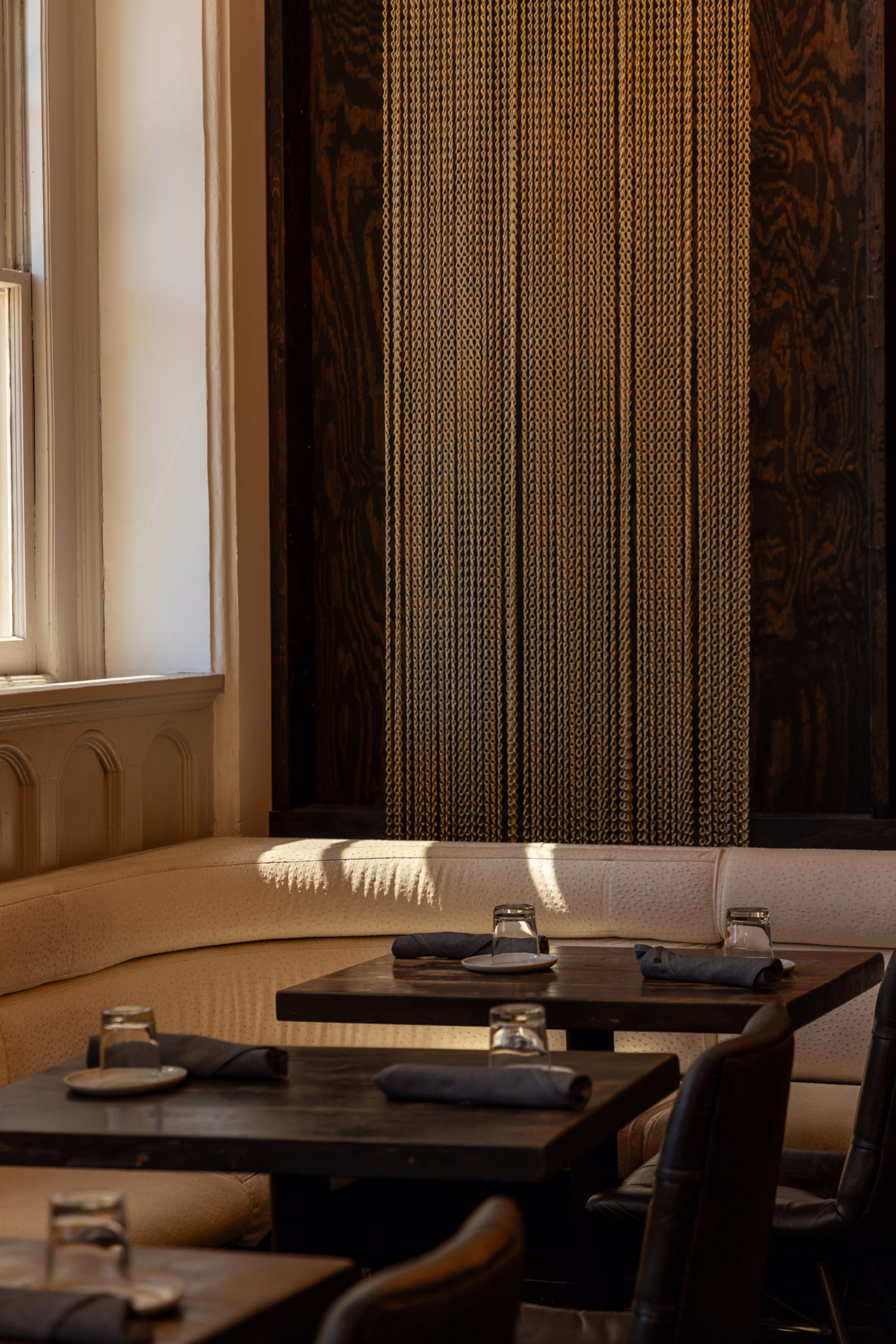 A corner banquette by the window at Divan