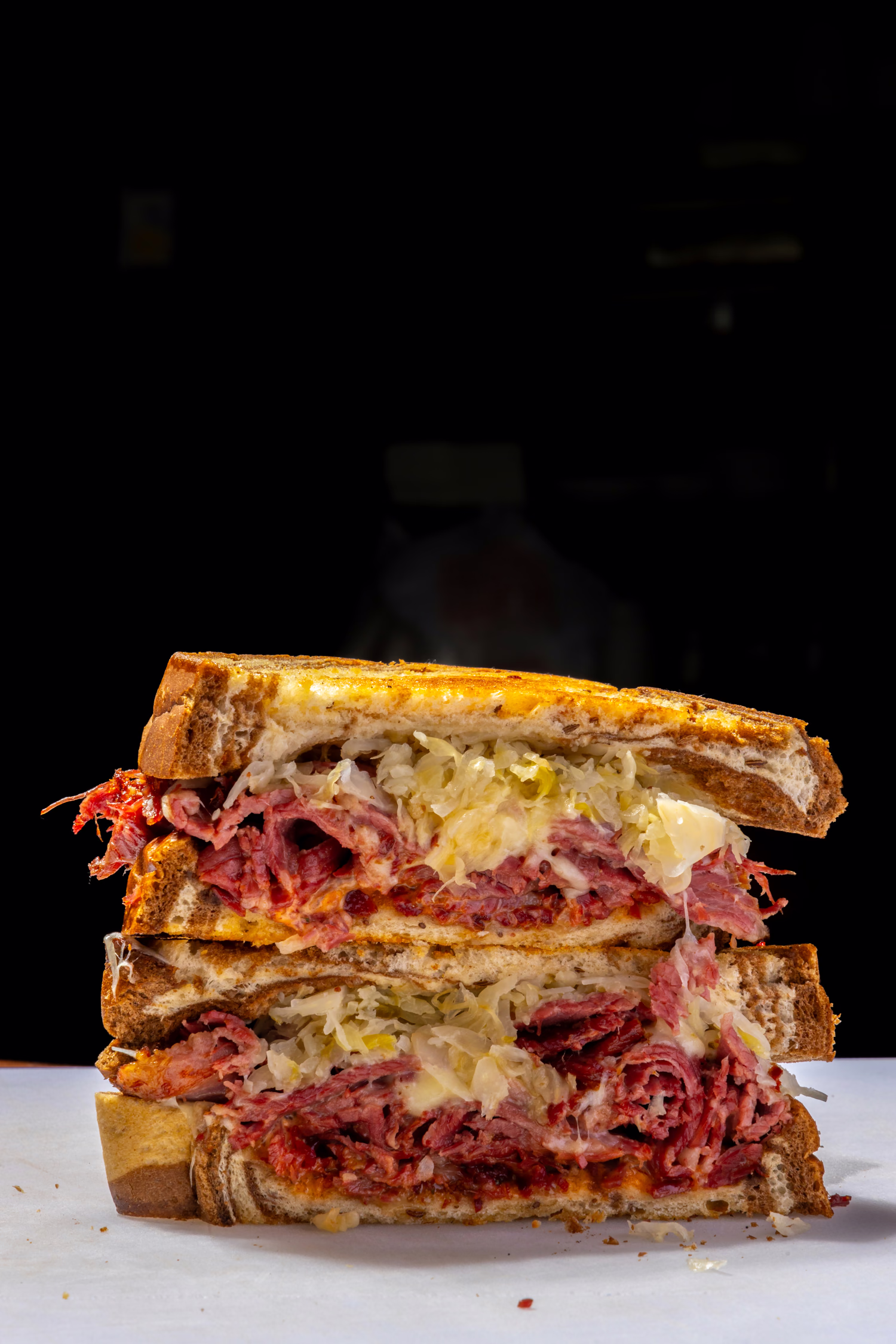 A Reuben sandwich cut and stacked to show the corned beef and sauerkraut at Dime Store