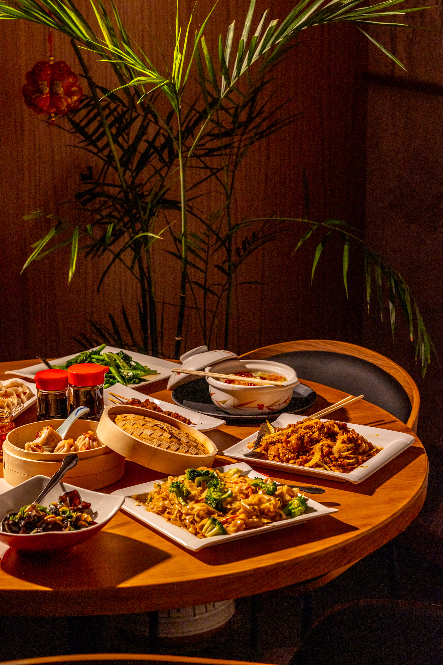 A round table laid with shared dishes at Northern China Eatery
