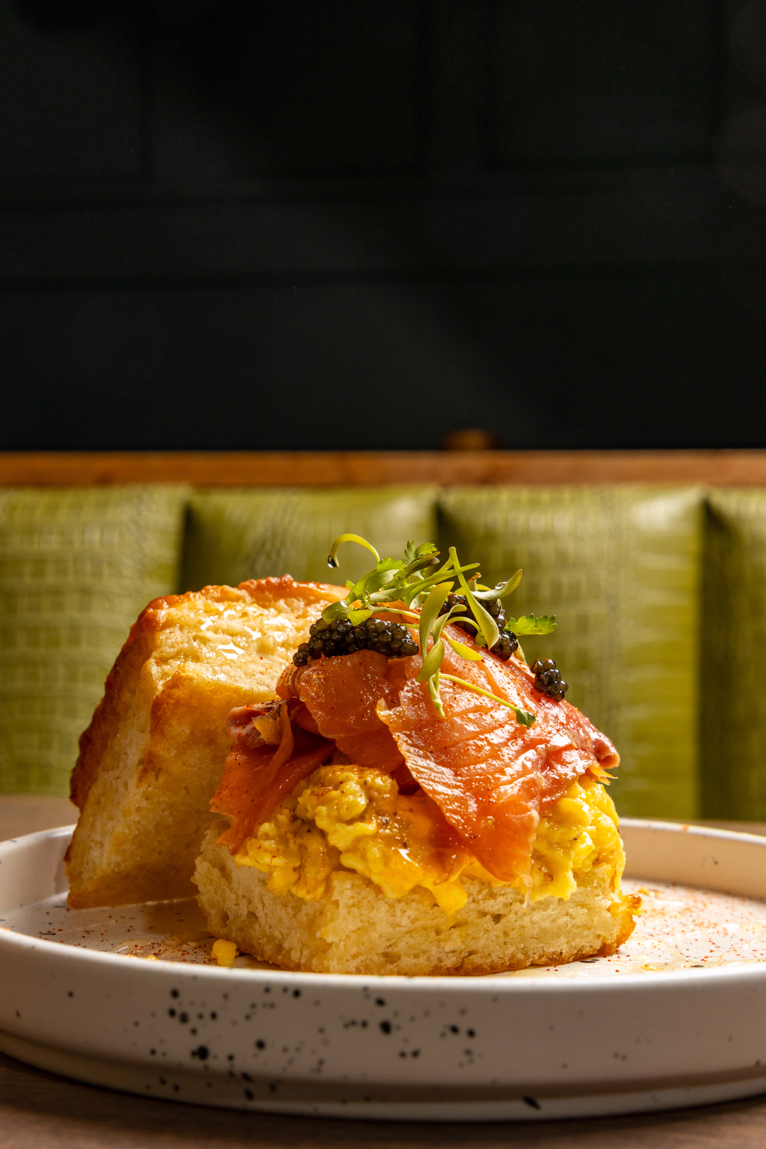 A biscuit piled with scrambled eggs, smoked salmon and caviar at Auburn Angel