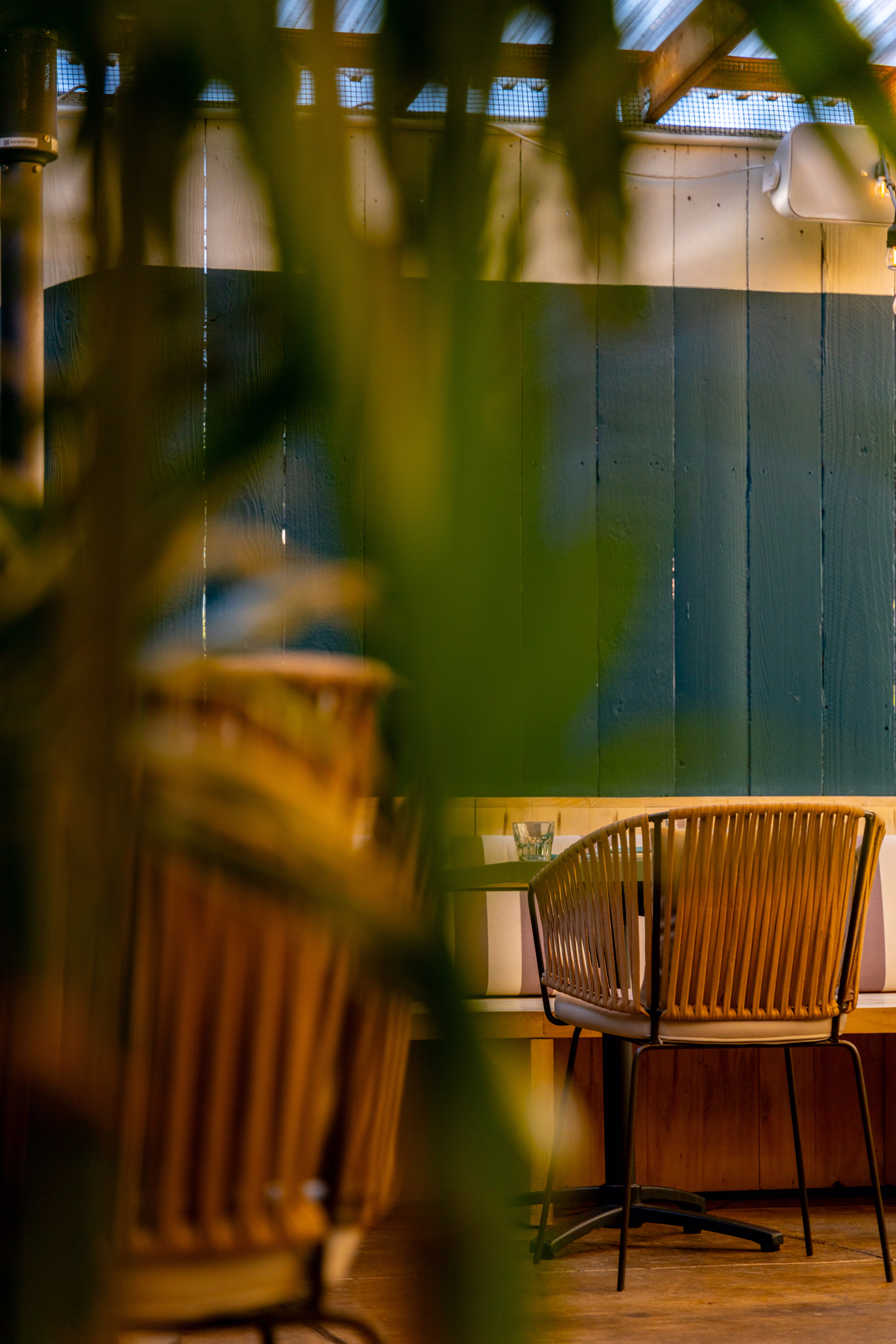 A table seen through palm leaves at Jo's Modern Thai
