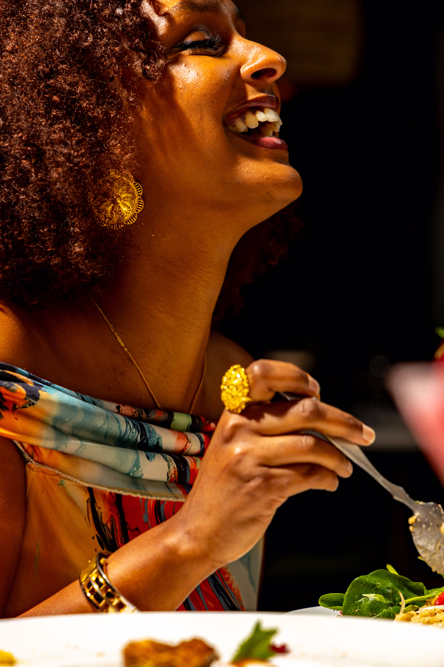 A guest laughing with a forkful of food at Verdure