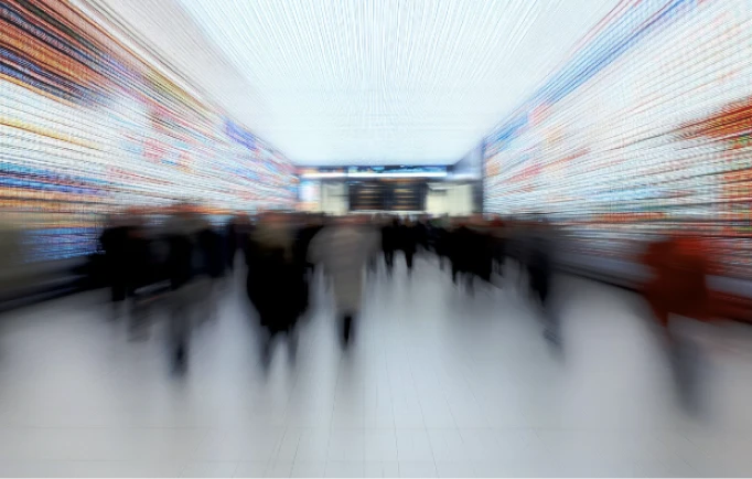 People moving through a busy concourse.