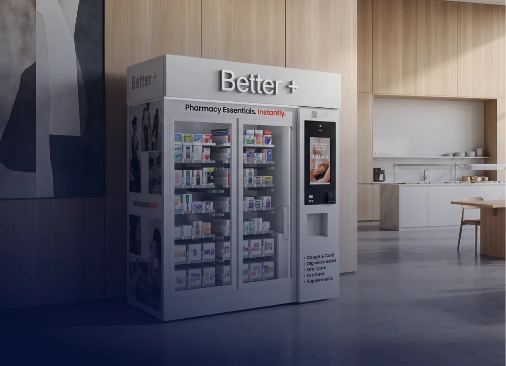 Better+ kiosk against a wood-paneled wall in a lobby.