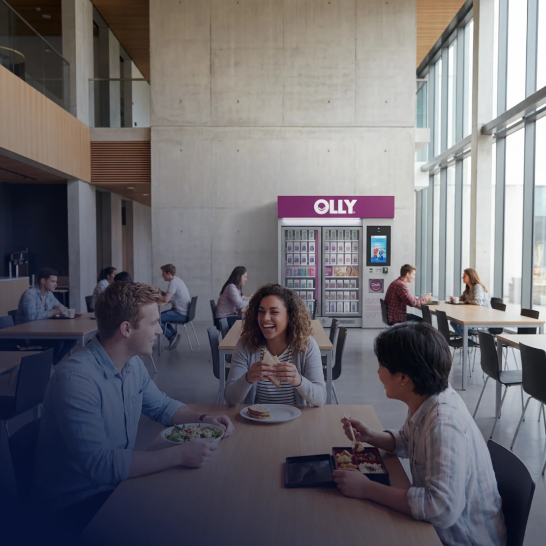 Students eating and talking near an OLLY kiosk.