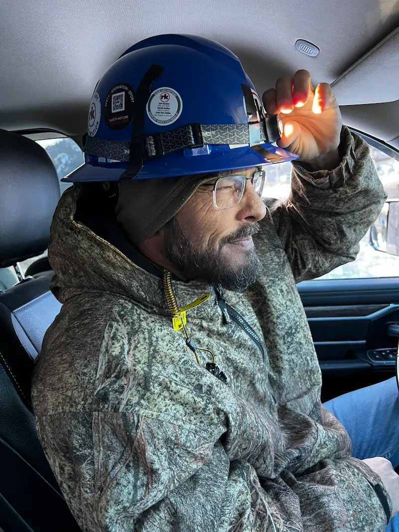 Mr. Perfect Plumbing technician wearing a hard hat and headlamp
