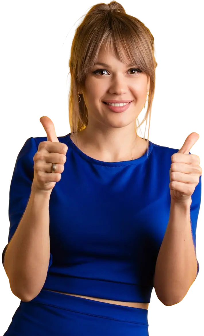 Smiling young woman with light brown hair wearing a blue top giving two thumbs up.