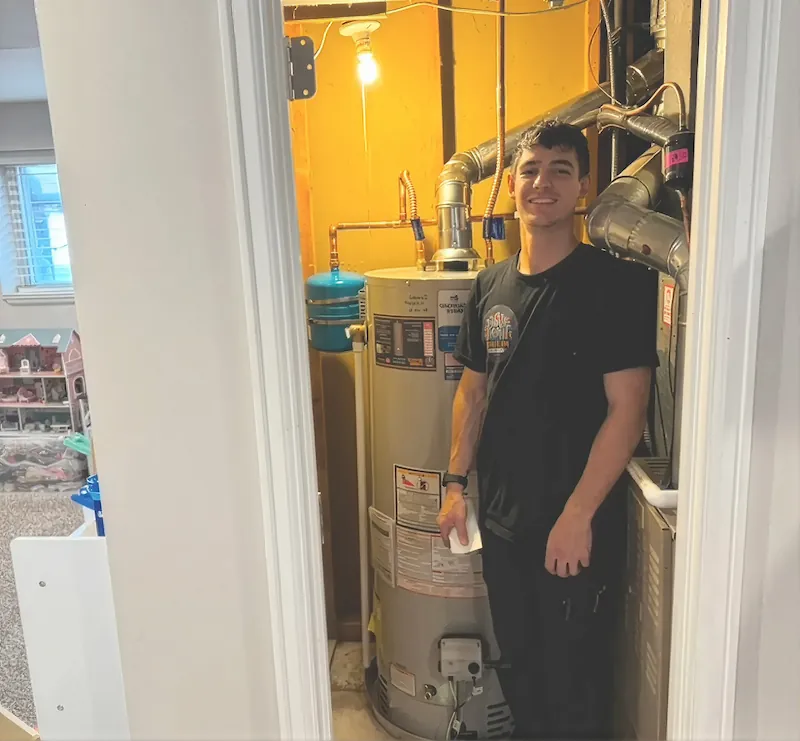 Mr. Perfect Plumbing technician next to the company service van