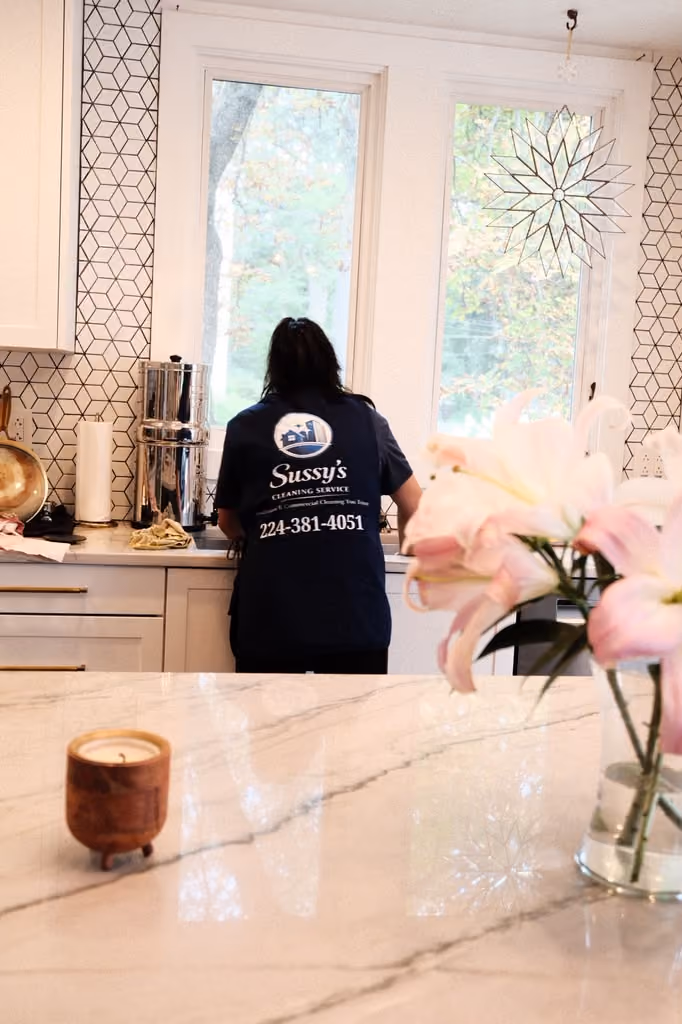 A Sussy's cleaner at work in a bright client kitchen