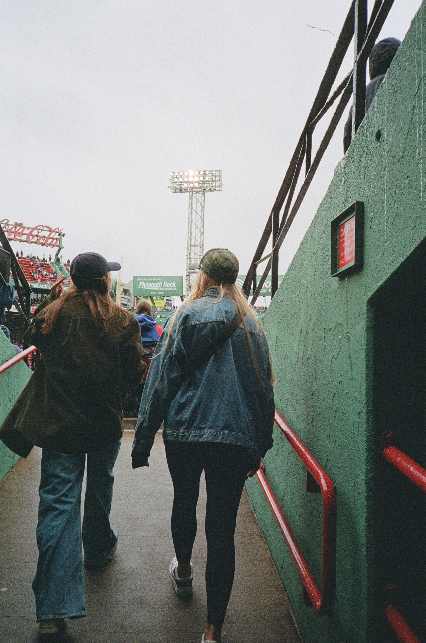 Two friends walking into a baseball stadium