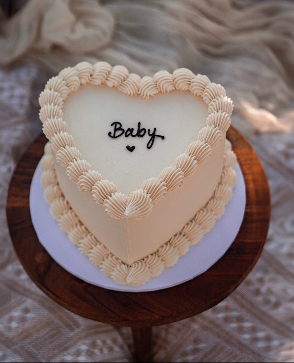 Heart-shaped cake with Baby written in icing