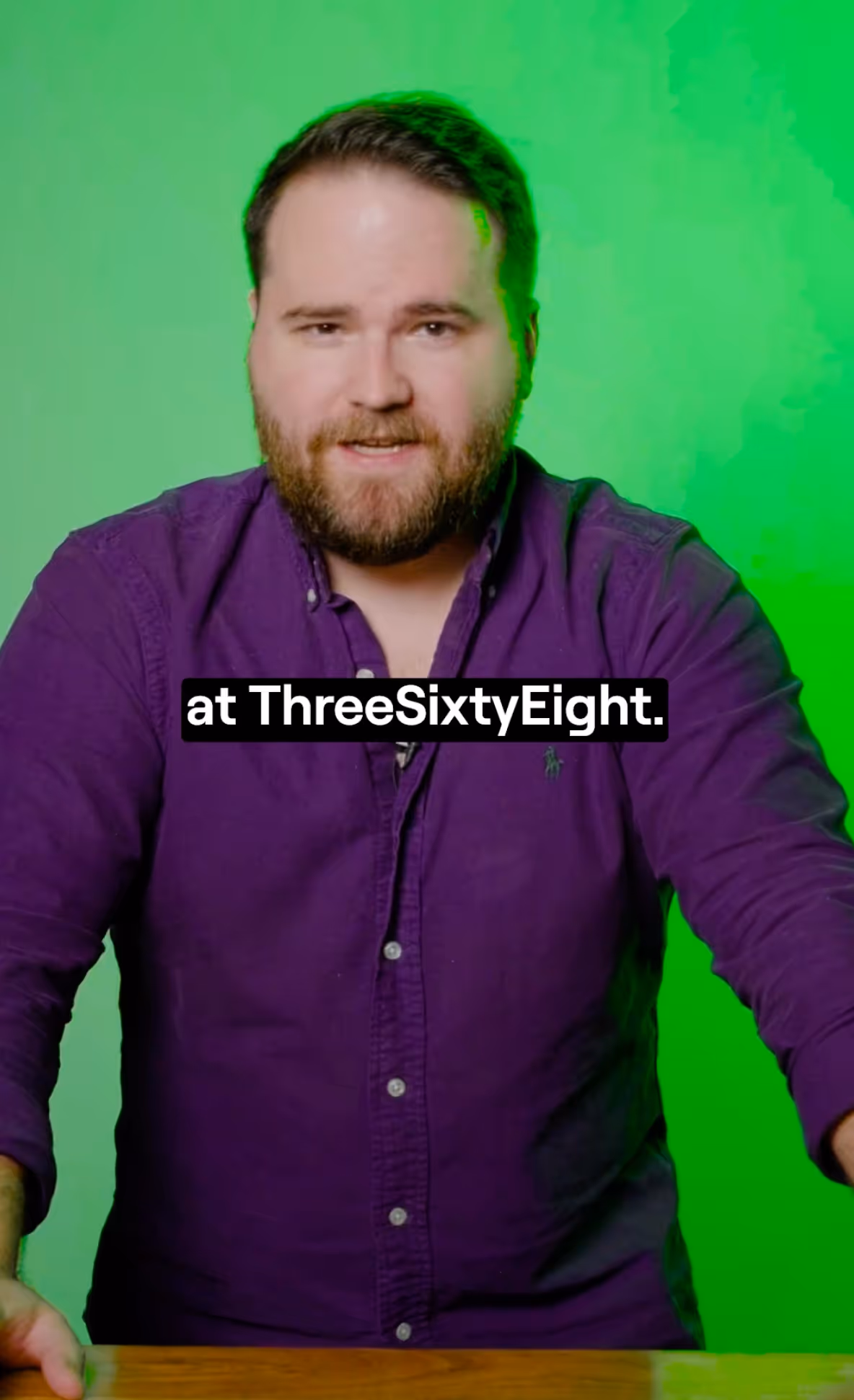Man with beard wearing a purple button-up shirt standing at a wooden table with a green background and text overlay reading 'at ThreeSixtyEight.'