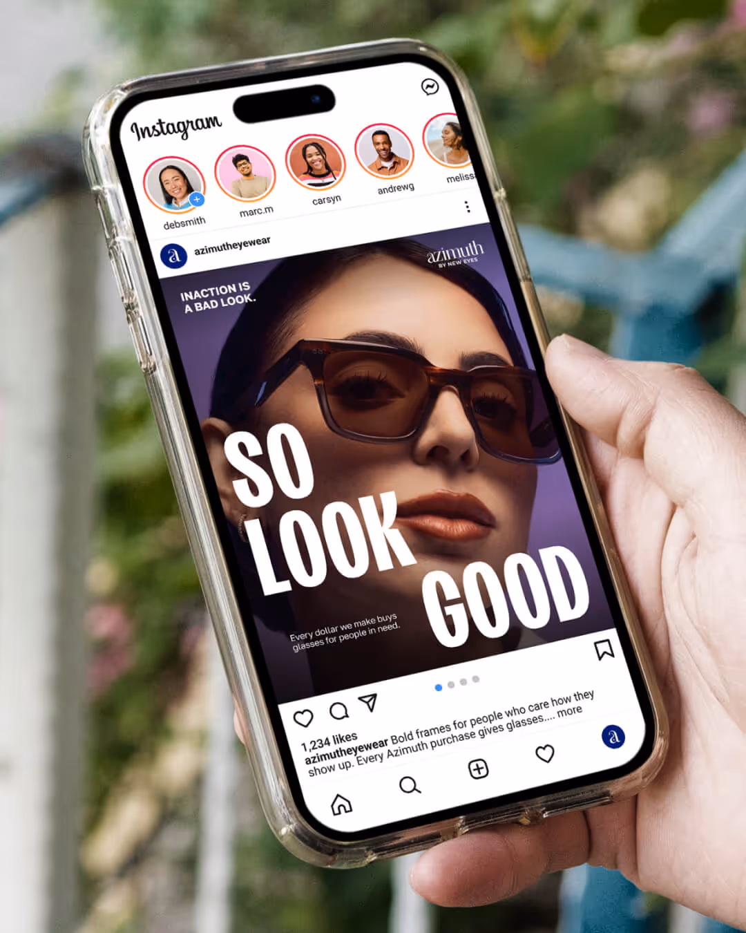 Hand holding smartphone displaying an Instagram ad for Azimuth Eyewear featuring a woman wearing large sunglasses with text 'SO LOOK GOOD' and 'Inaction is a bad look.'